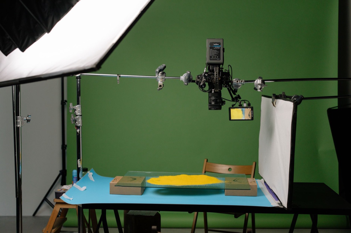 A professional video editing workstation with dual monitors showing color grading interfaces.