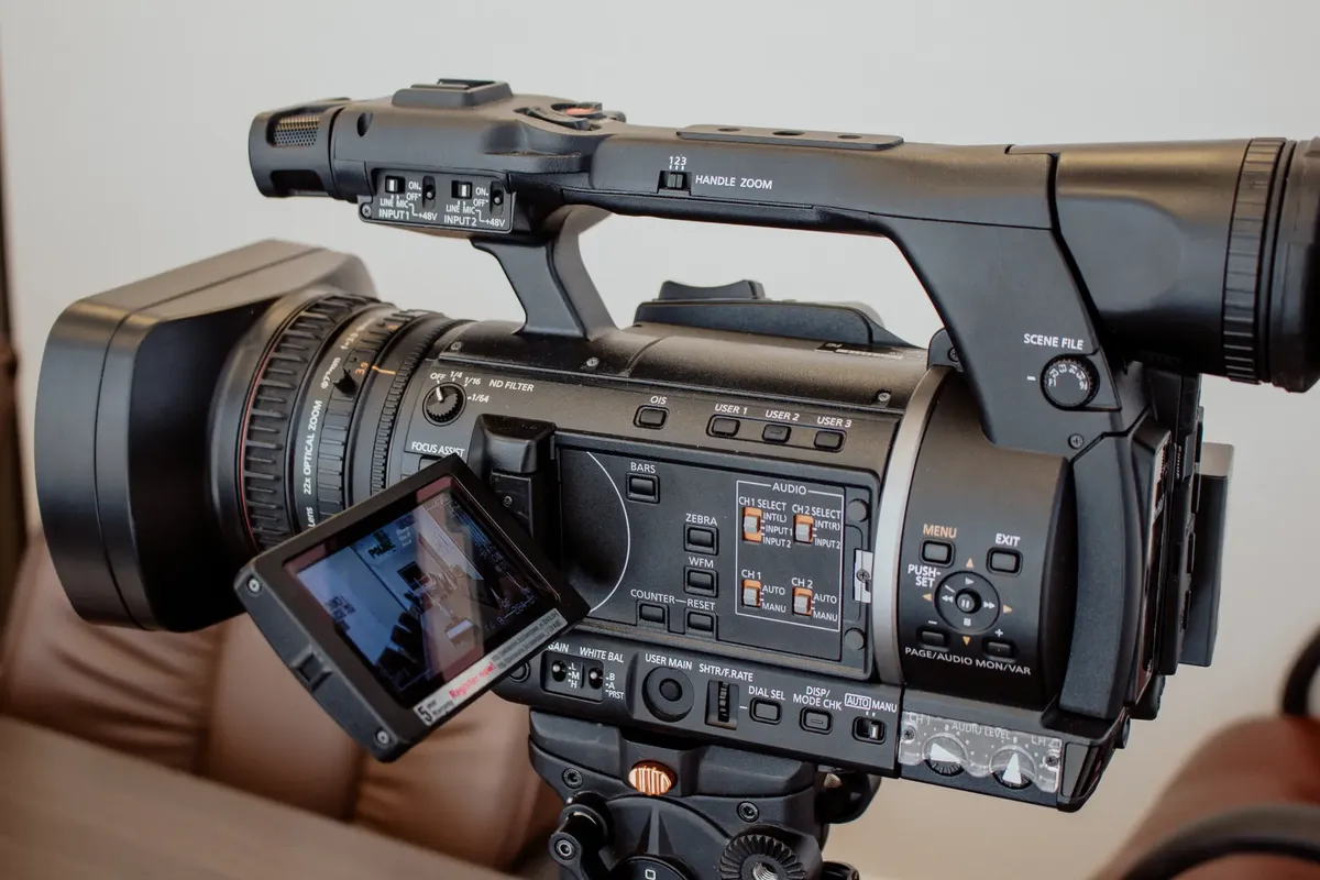 High-quality close-up of a professional video camera setup indoors, ideal for media-related work.