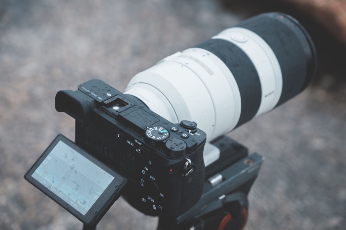mirrorless camera with lens on tripod